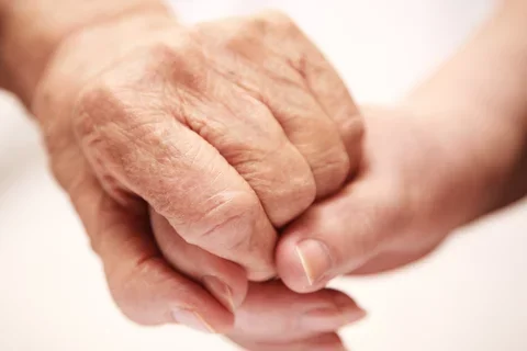 Young and old hands together
