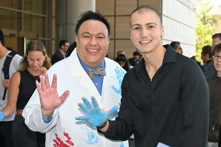 Dr. Steven J. Jonas and cancer survivor Sina Sinbari celebrate the $400,000 Hyundai Scholar Hope grant for pediatric cancer research.