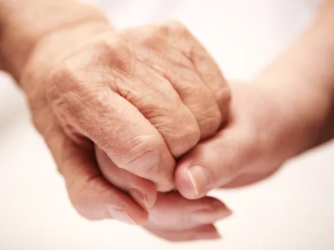 Young and old hands together
